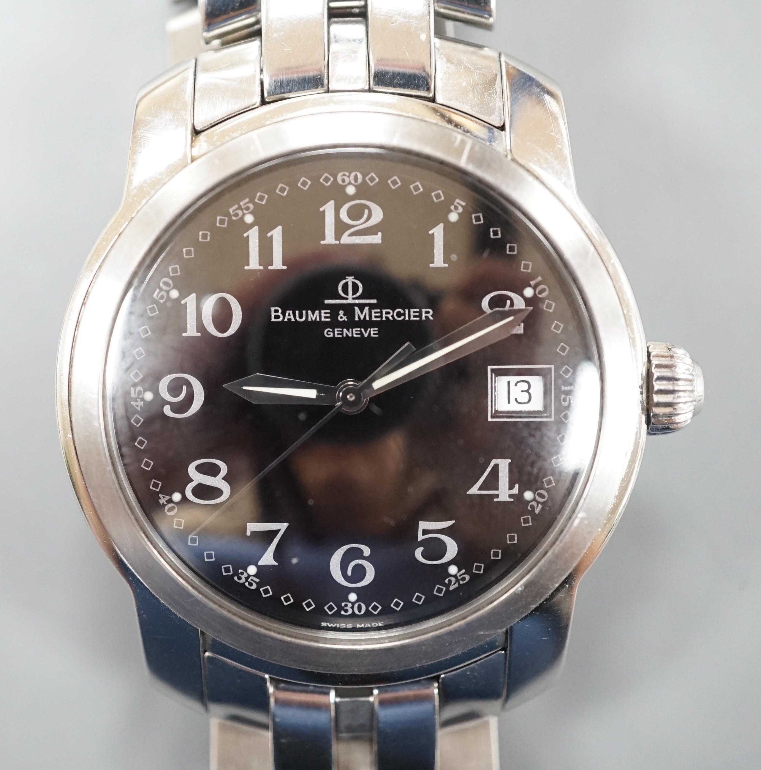 A gentleman's stainless steel Baume & Mercier quartz wrist watch, with black Arabic dial and date aperture, case diameter 37mm, with spare links, no box or papers.